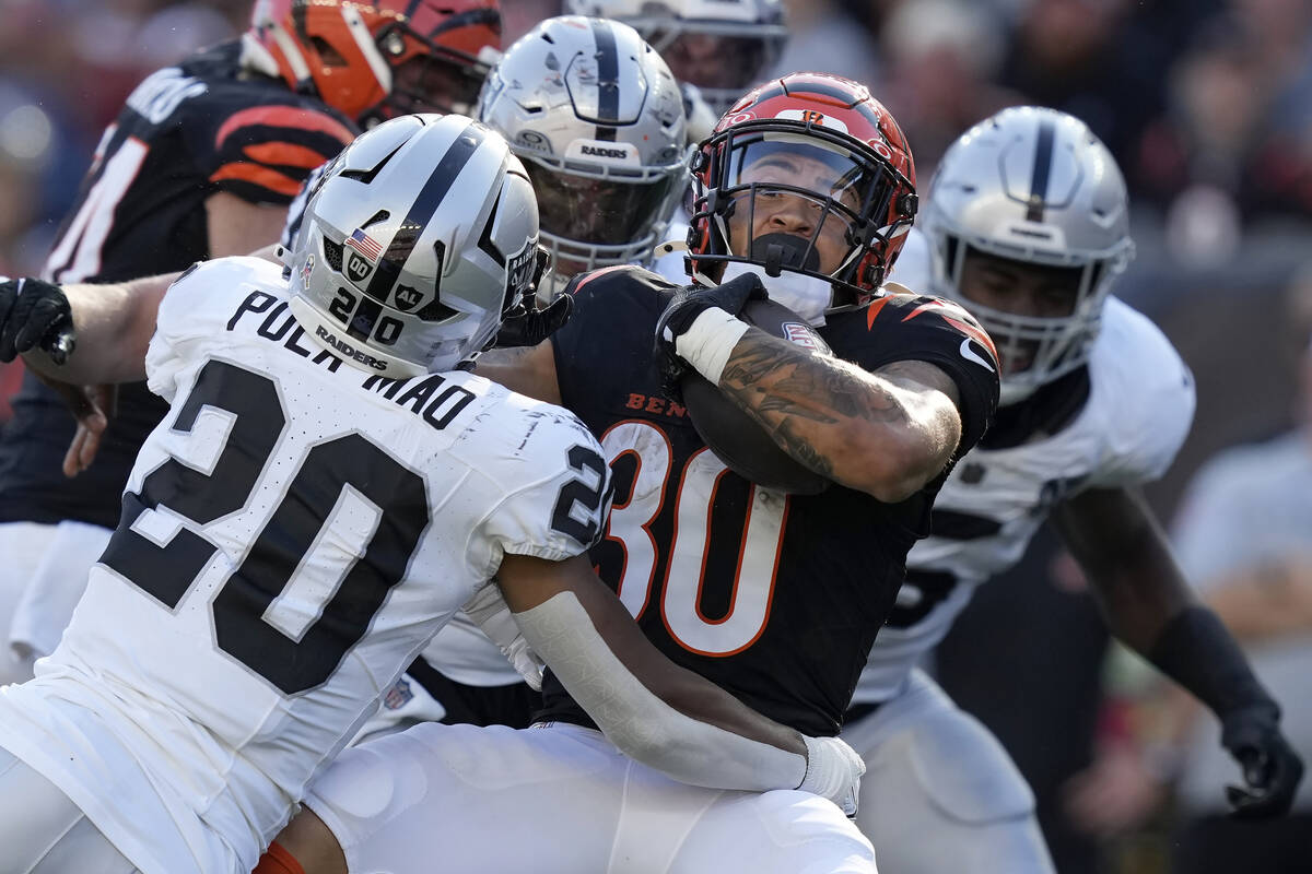 Las Vegas Raiders safety Isaiah Pola-Mao (20) and teammates tackle Cincinnati Bengals running b ...