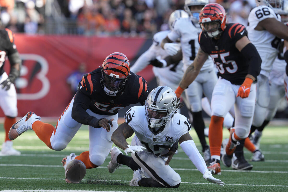 Las Vegas Raiders wide receiver DJ Turner, bottom, tries to recover a fumble by quarterback Gar ...