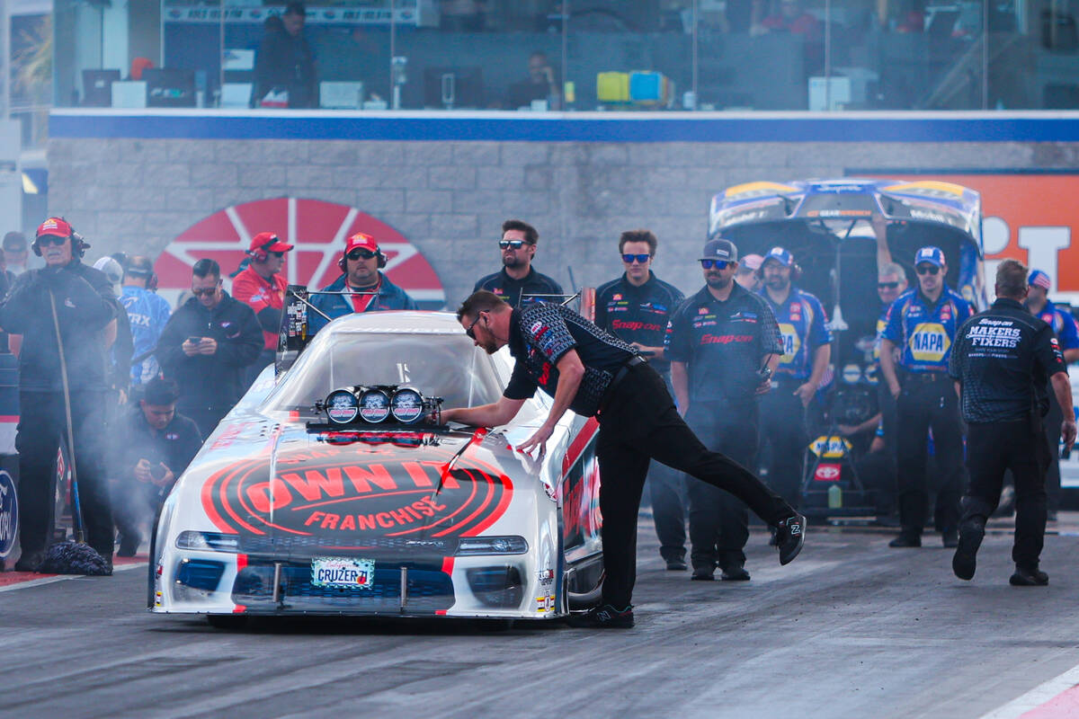 NHRA driver Cruz Pedregon’s car is checked before a race during the NHRA Funny Car quart ...