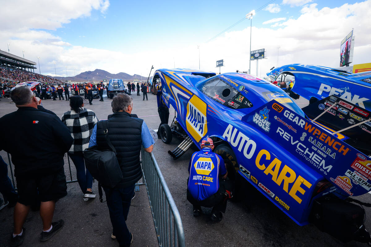 NHRA driver Ron Capps’ car is worked on before a race during the NHRA Funny Car quarterf ...