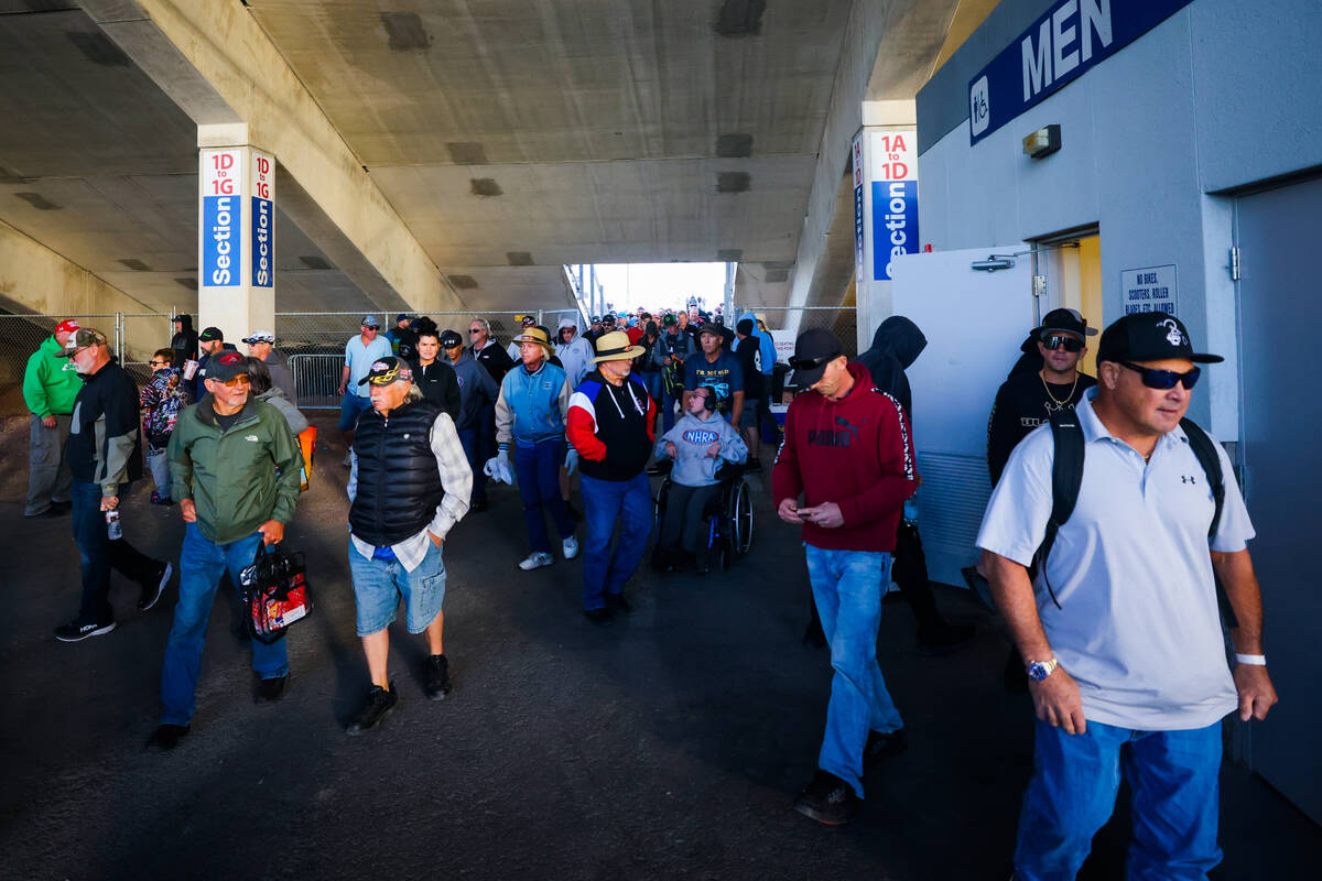 NHRA fans leave the stands during a halt in racing after NHRA Top Fuel driver Shawn Langdon ble ...