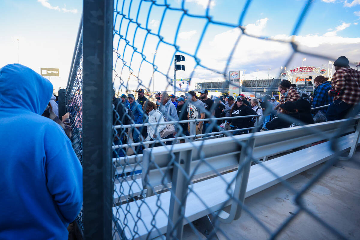 NHRA fans leave the stands during a halt in racing after NHRA driver Shawn Langdon blew a tire ...