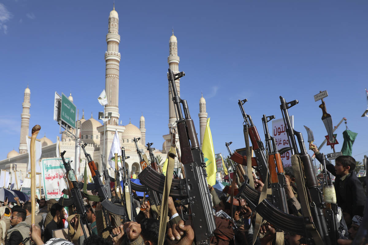 Houthi supporters raise their machine guns during an Anti- U.S and Israel rally in Sanaa, Yemen ...