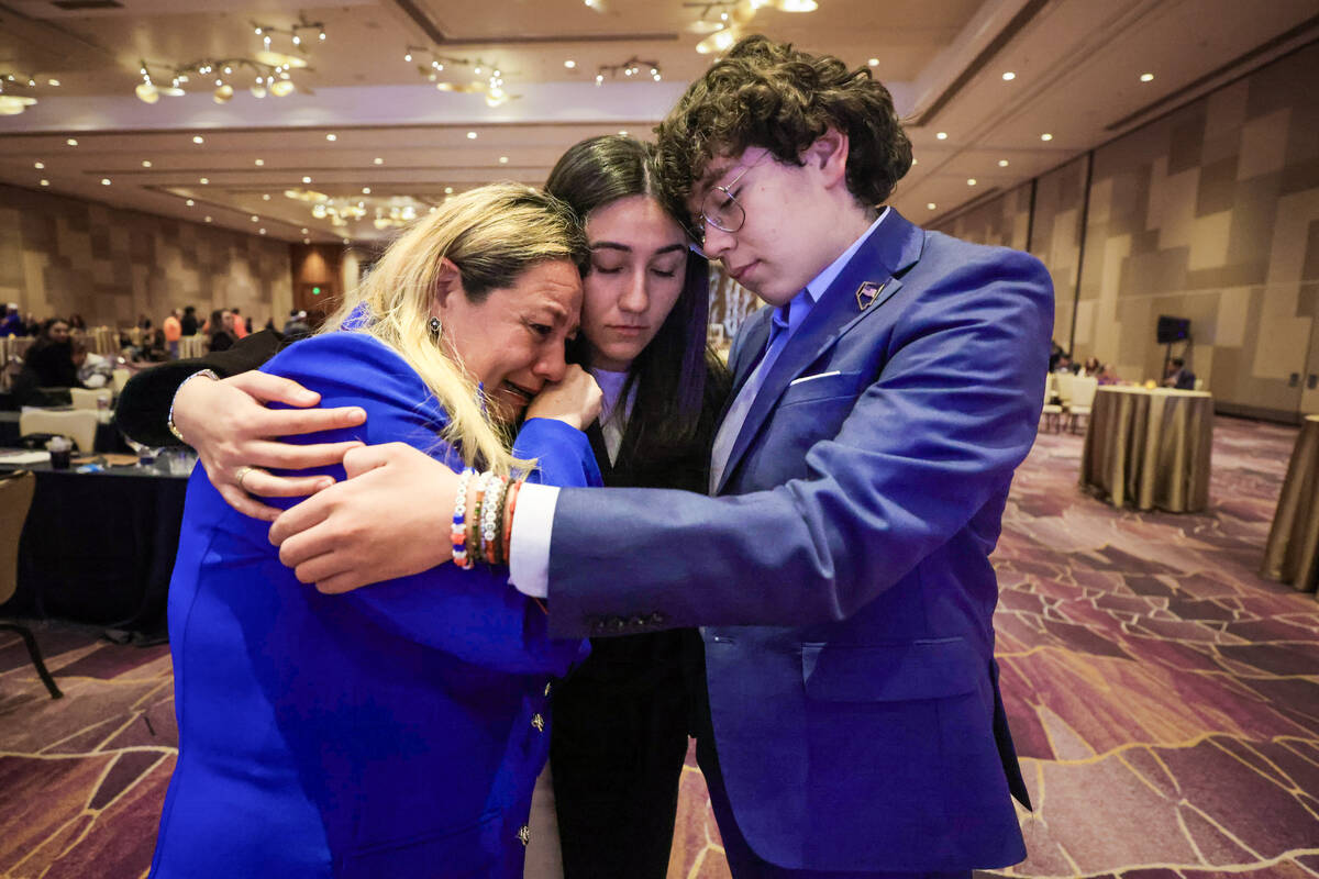 Carolyn Salvador Avila, middle, hugs and comforts her mom, Carolina, and brother, Julian, as re ...