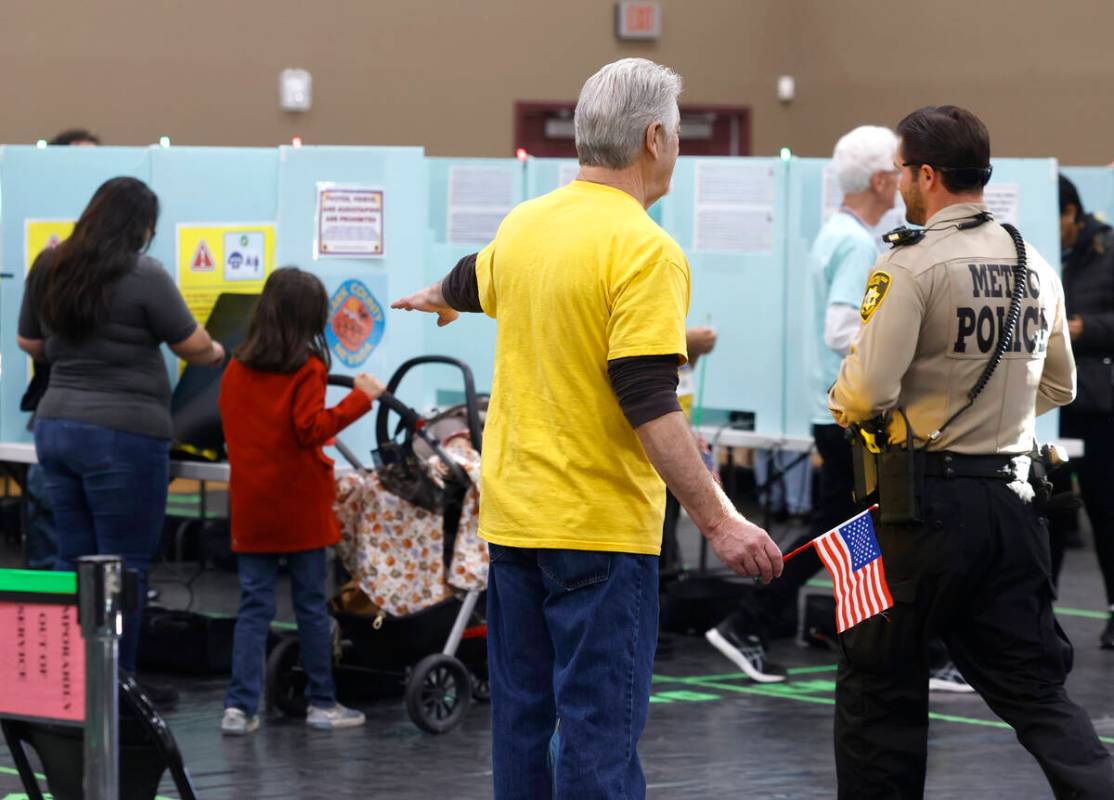 A poll worker directs a voter to a voting booth at Desert Breeze Community Center Tuesday, Nov. ...