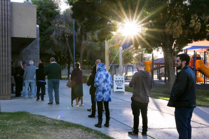 Voters wait in line for the doors to open at the Winchester Dondero Cultural Center polling cen ...