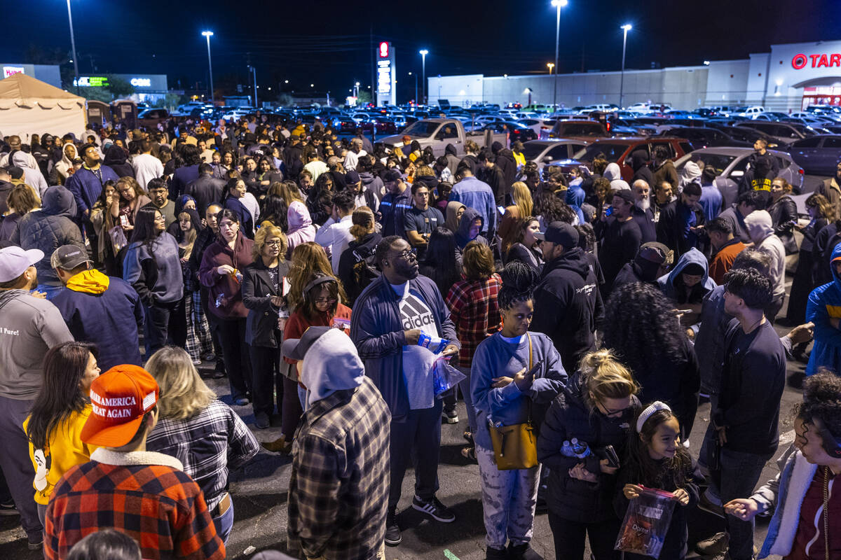 People wait in a long line to cast their ballots on Election Day at the Nellis Crossing Shoppin ...