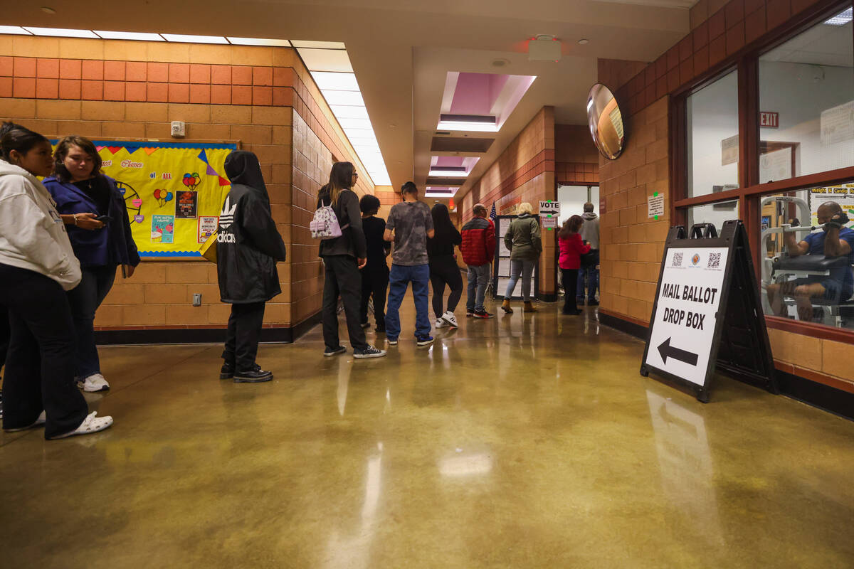 Voters line up to cast their ballots on Election Day evening at the Cambridge Recreation Center ...