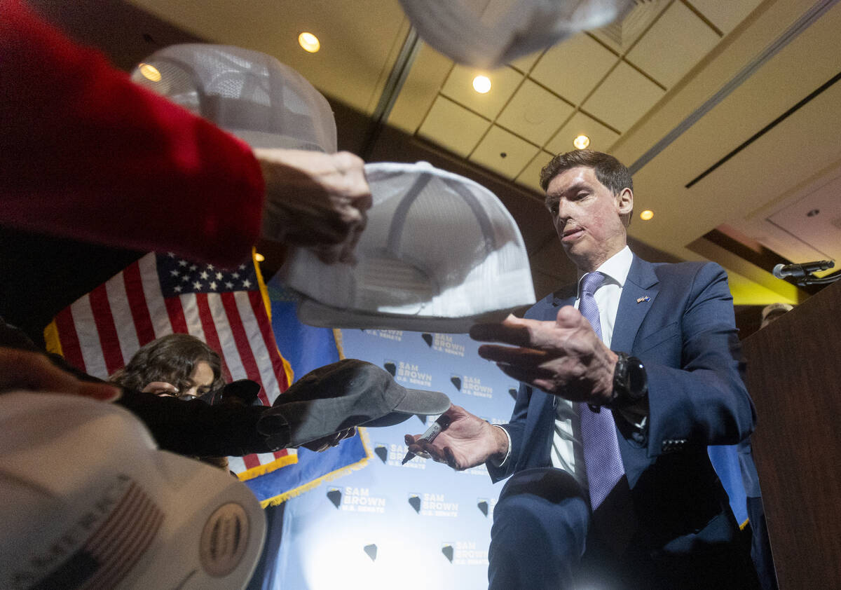 Republican senatorial candidate Sam Brown signs hats after giving a celebratory speech during h ...