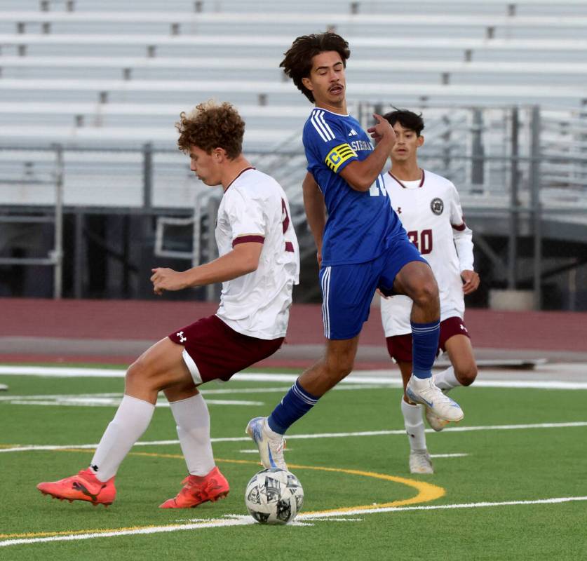 Sierra Vista forward Lazzar Ramos (10) moves the ball past Faith Lutheran defender Nicholas Fit ...