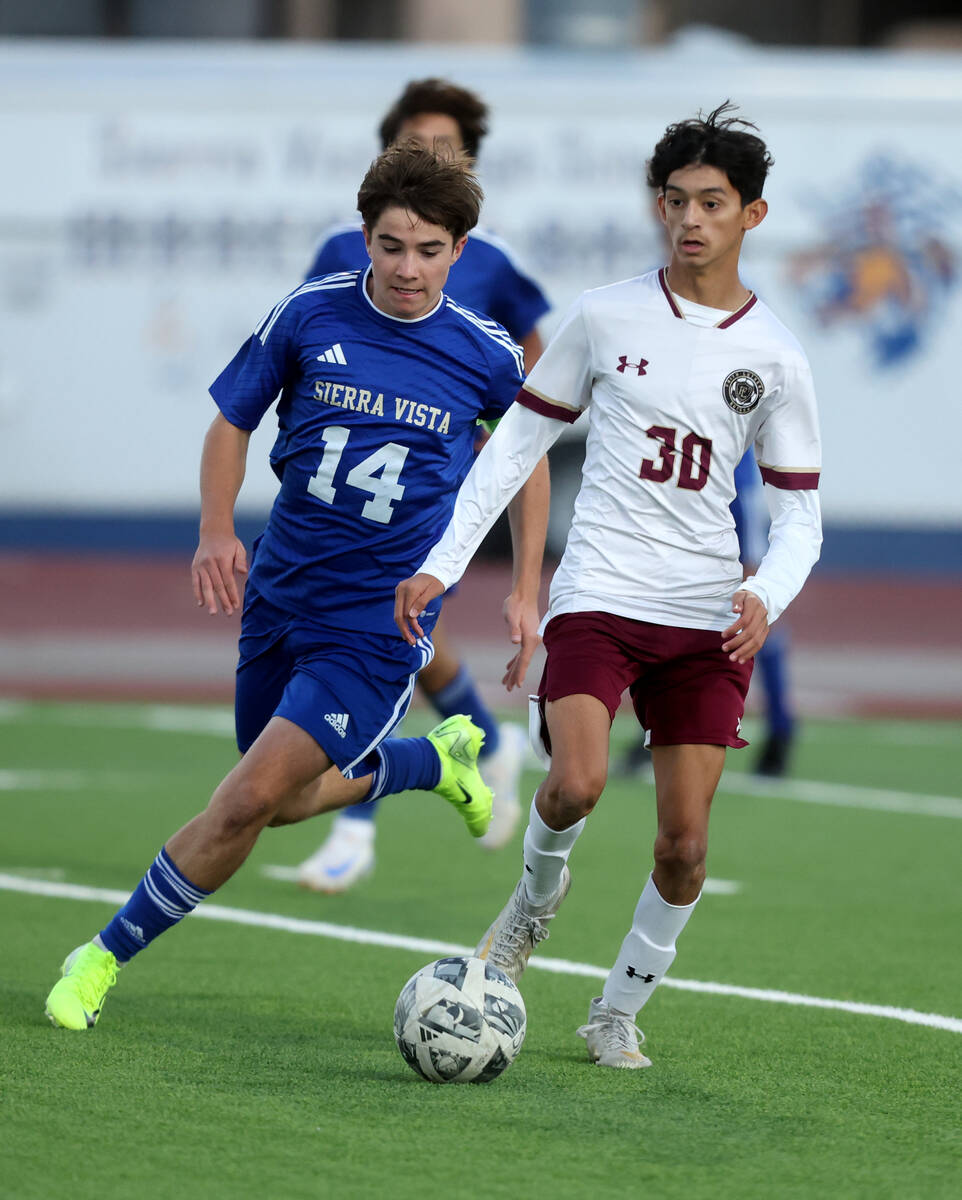 Faith Lutheran midfielder Troy DosSantos (30) dribbles the ball past Sierra Vista defender Camd ...