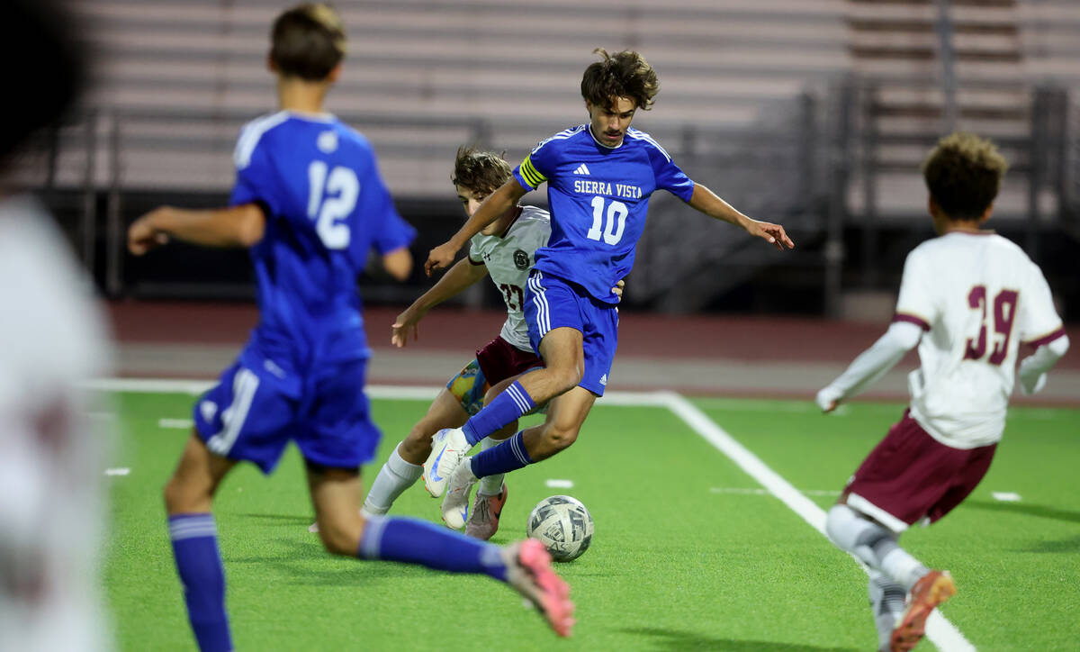 Sierra Vista forward Lazzar Ramos (10) dribbles the ball past Faith Lutheran forward Jesse Tayl ...