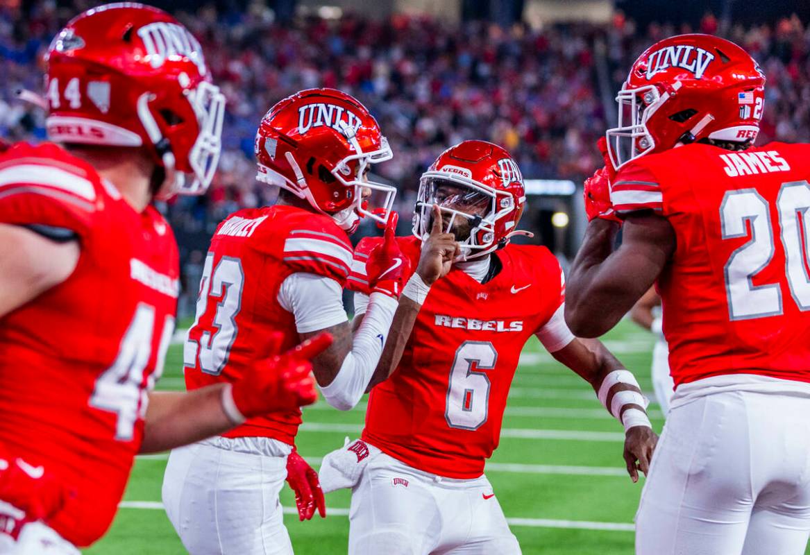 UNLV wide receiver Jaden Bradley (23) and quarterback Hajj-Malik Williams (6) hush the crowd af ...