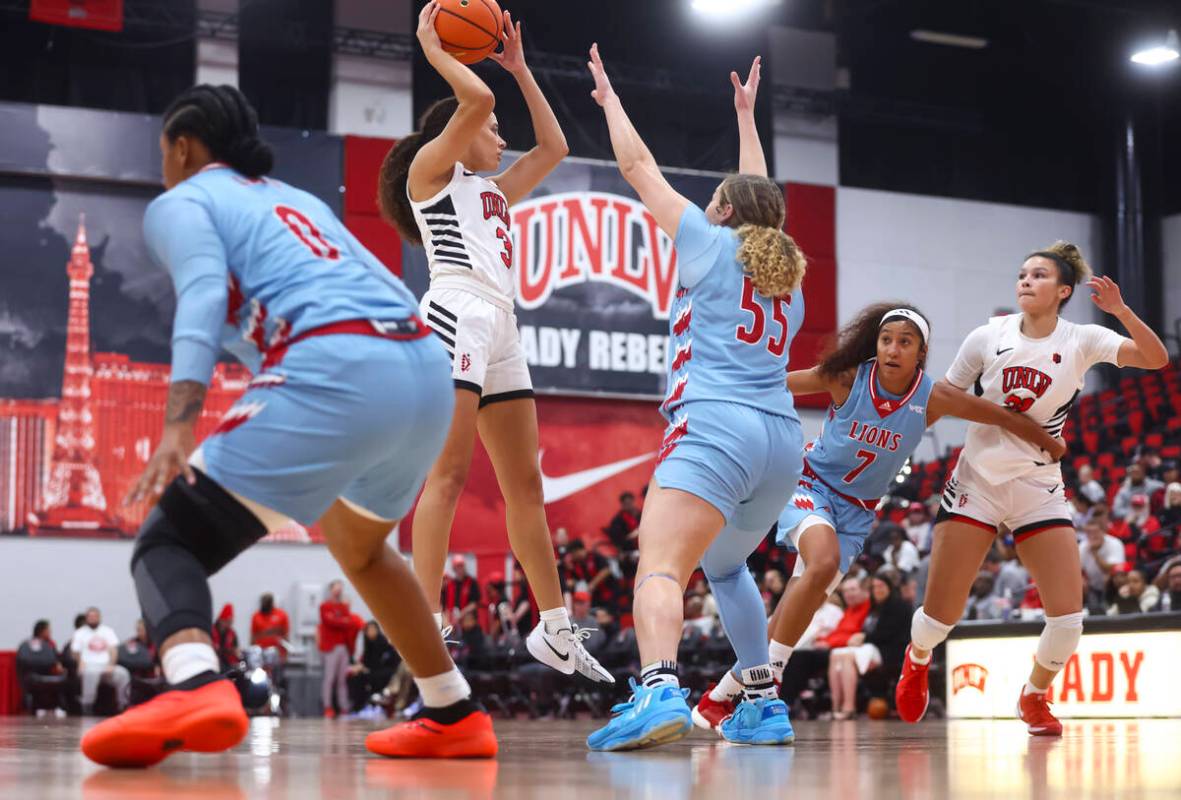 UNLV Lady Rebels guard Kiara Jackson (3) looks to pass the ball under pressure from Loyola Mary ...