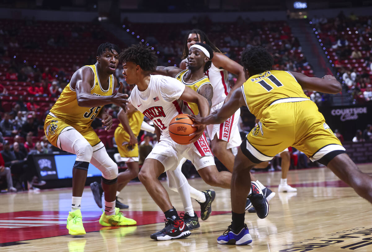 UNLV Rebels guard Dedan Thomas Jr. (11) drives to the basket between Alabama State Hornets cent ...