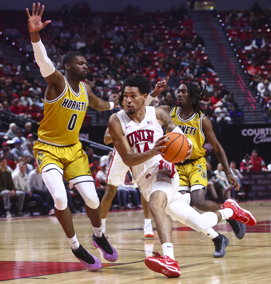 UNLV Rebels guard Jailen Bedford (14) drives to the basket against Alabama State Hornets forwar ...