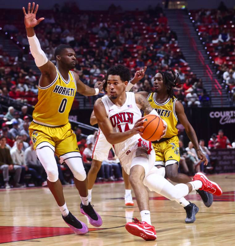 UNLV Rebels guard Jailen Bedford (14) drives to the basket against Alabama State Hornets forwar ...