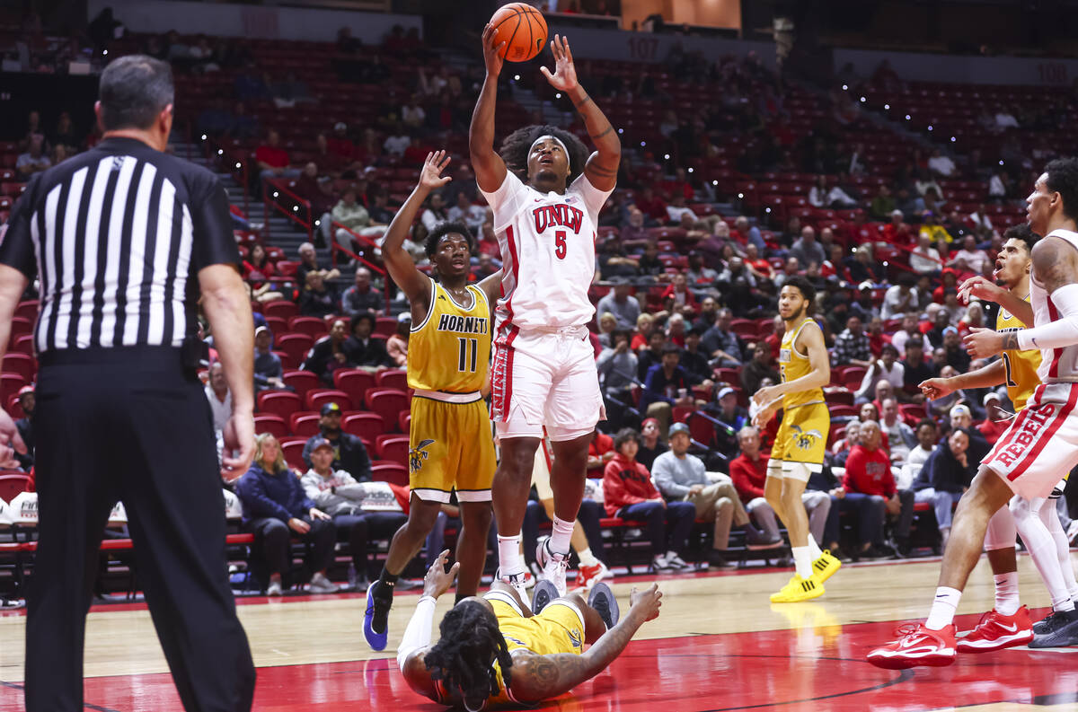 UNLV Rebels forward Rob Whaley Jr. (5) shoots in front of Alabama State Hornets guard Micah Oct ...