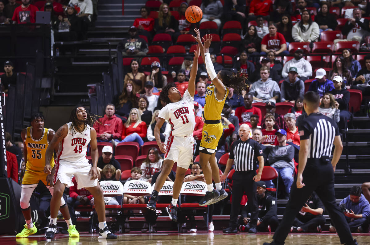 Alabama State Hornets guard CJ Hines (3) shoots over UNLV Rebels guard Dedan Thomas Jr. (11) du ...