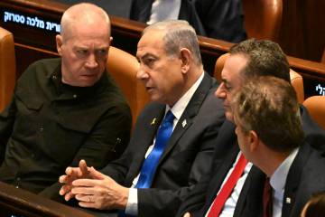 Israeli Prime Minister Benjamin Netanyahu, center, speaks to Defense Minister Yoav Gallant, lef ...