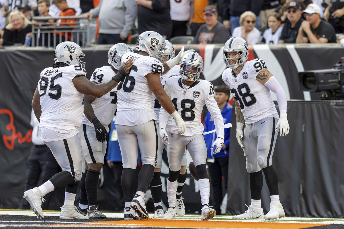 Las Vegas Raiders cornerback Jack Jones (18) is congratulated by teammates after scoring a touc ...