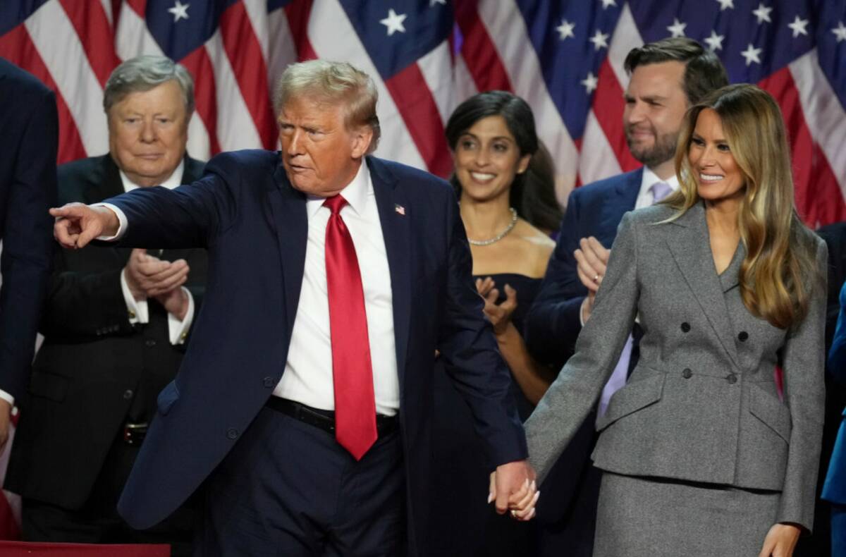 Donald Trump holds hands with former first lady Melania Trump after speaking to supporters at t ...