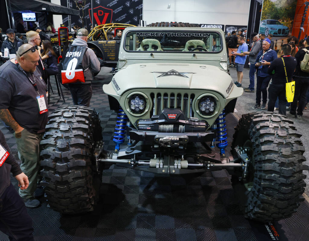 Attendees check out Rockstar GRDLOC Jeep during the first day of SEMA at the Las Vegas Conventi ...