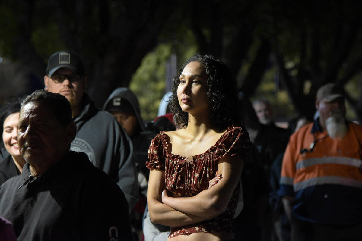 Arms folded, an unidentified woman waits in a line of voters at the Bob Rudd community center i ...