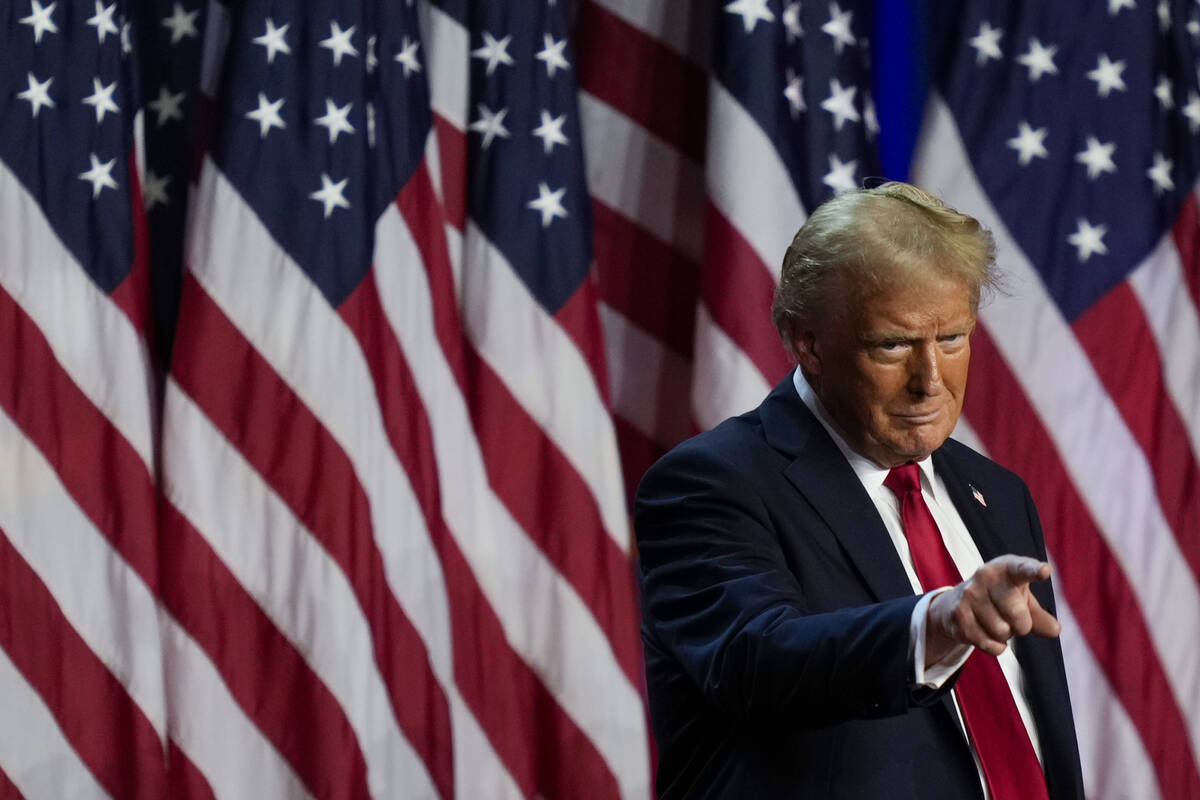 Republican presidential nominee former President Donald Trump points to the crowd at an electio ...