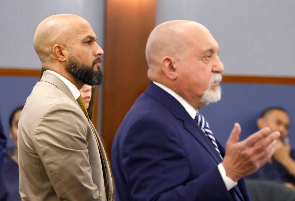 Metropolitan Police Department Sgt. Kevin Menon, left, listens as his attorney Dominic Gentile ...