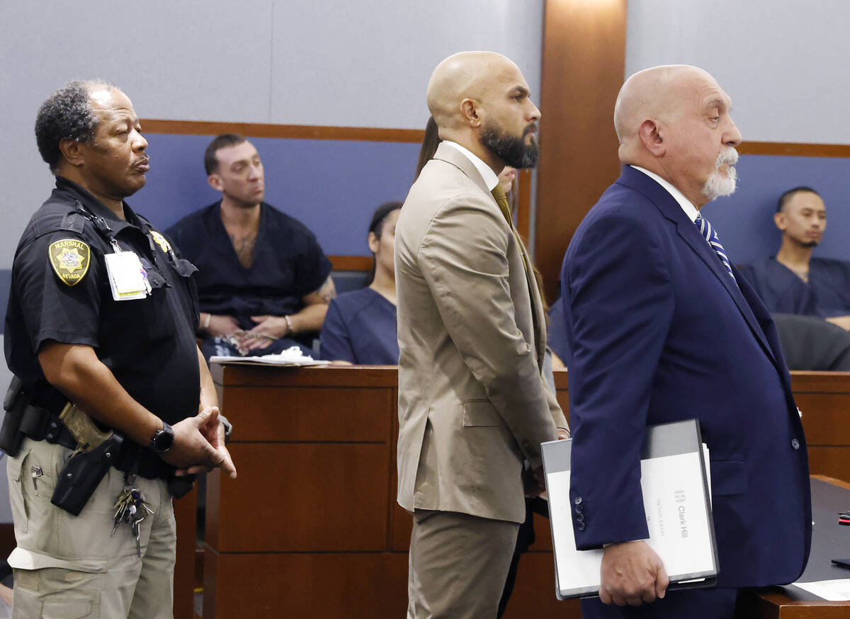 Metropolitan Police Department Sgt. Kevin Menon, center, appears in court with his attorney Dom ...