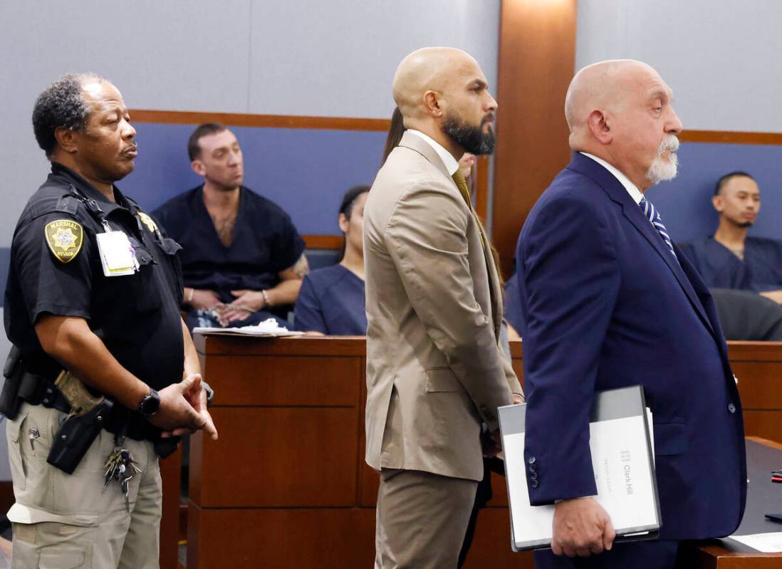 Metropolitan Police Department Sgt. Kevin Menon, center, appears in court with his attorney Dom ...