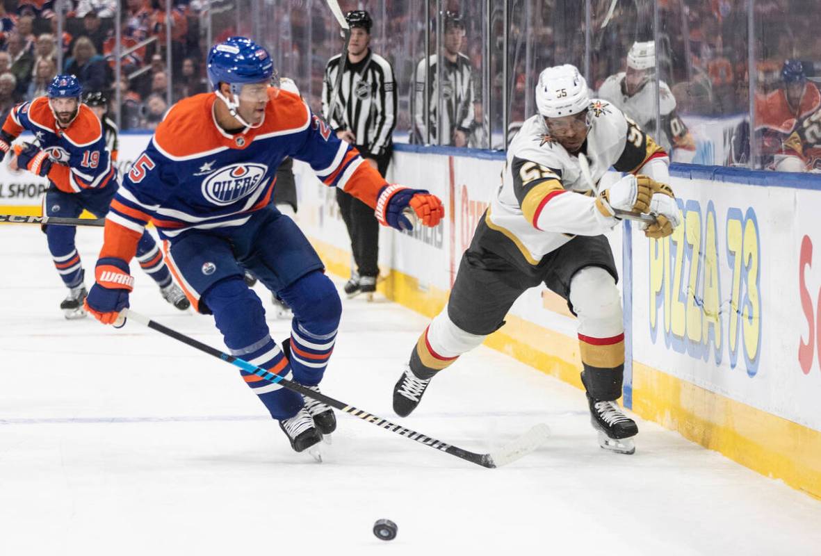 Vegas Golden Knights' Keegan Kolesar (right) and Edmonton Oilers' Darnell Nurse (25) race for t ...