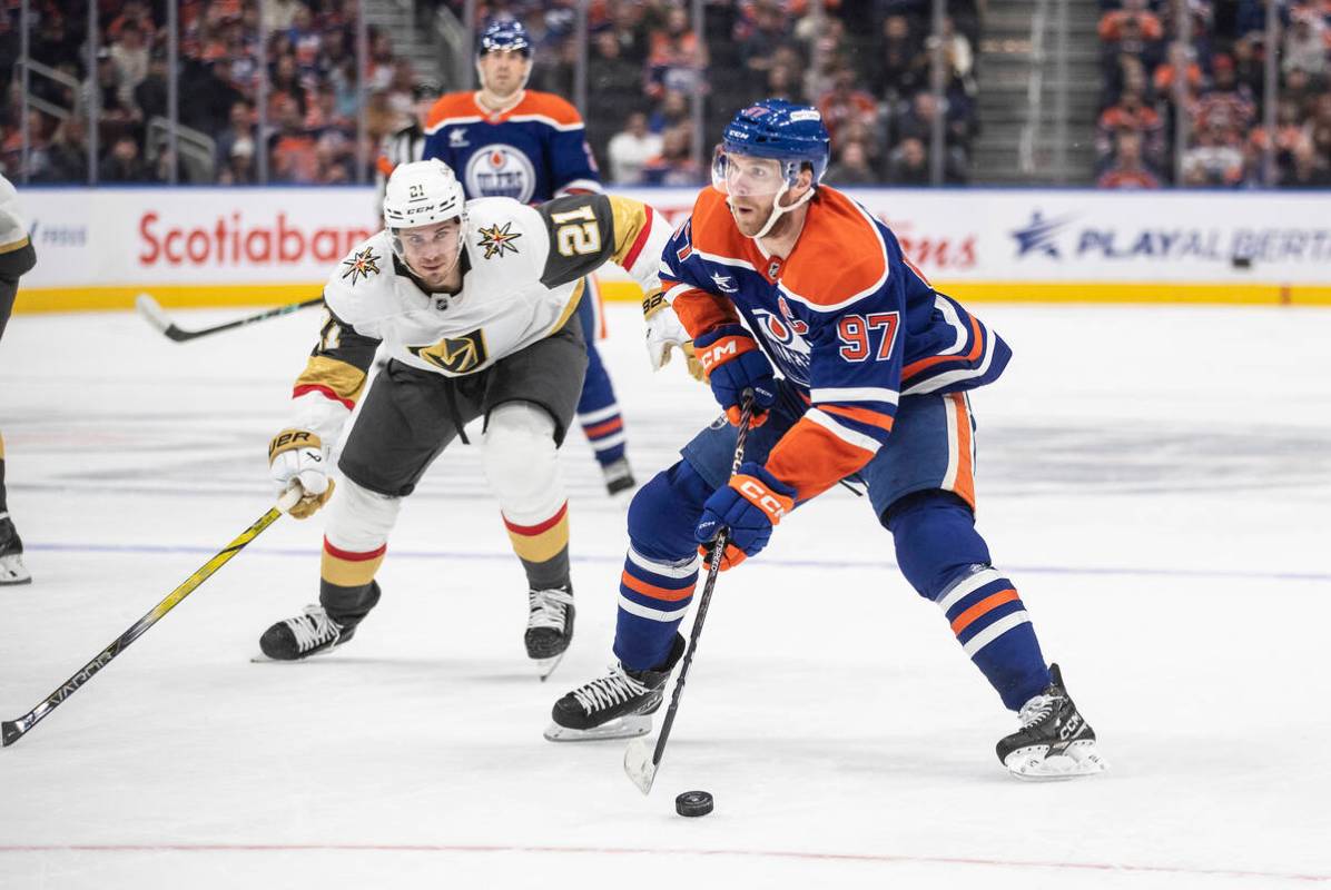 Vegas Golden Knights' Brett Howden (21) chases Edmonton Oilers' Connor McDavid (97) during the ...