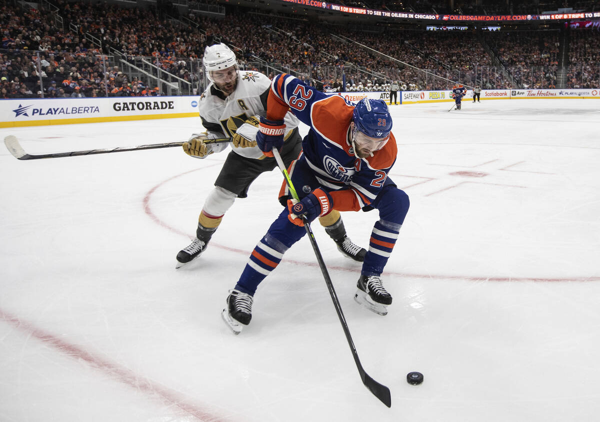 Vegas Golden Knights' Alex Pietrangelo, left, and Edmonton Oilers' Leon Draisaitl (29) battle f ...