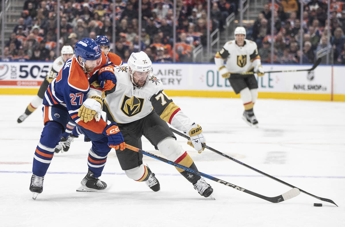 Vegas Golden Knights' Tanner Pearson (70) and Edmonton Oilers' Brett Kulak (27) battle for the ...