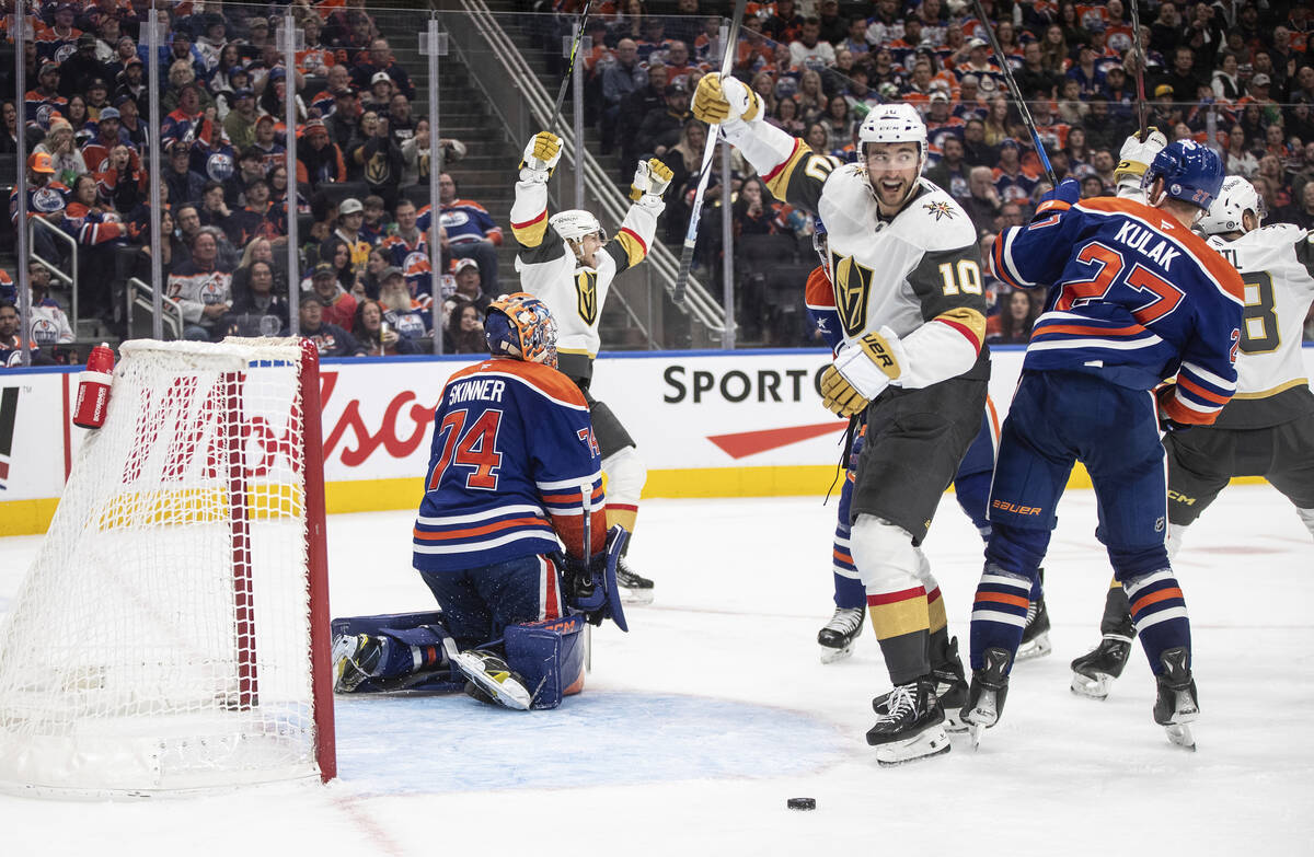 Vegas Golden Knights' William Karlsson (back left) and Nicolas Roy (10) react as the puck goes ...