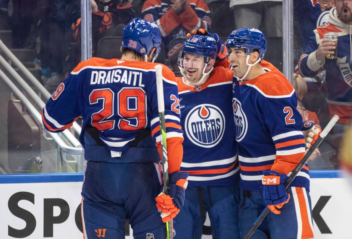 Edmonton Oilers' Leon Draisaitl (29), Zach Hyman (18) and Evan Bouchard (2) celebrate a goal ag ...