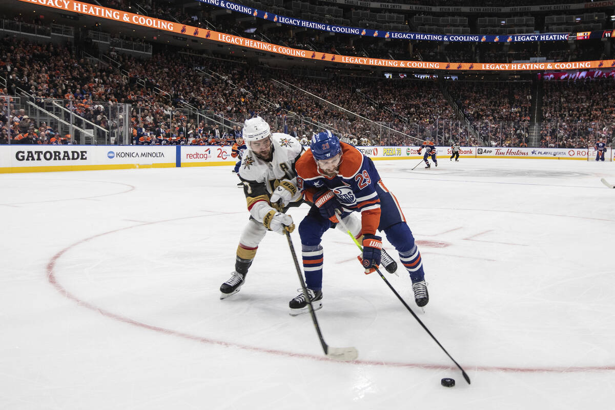 Vegas Golden Knights' Alex Pietrangelo, left, and Edmonton Oilers' Leon Draisaitl (29) battle f ...