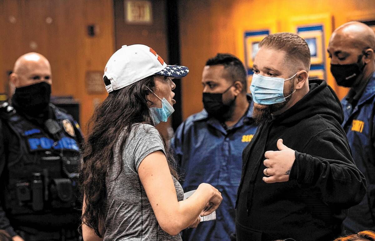 Lorena Cardenas of My Children's Advocate is escorted out of the Clark County School Board meet ...