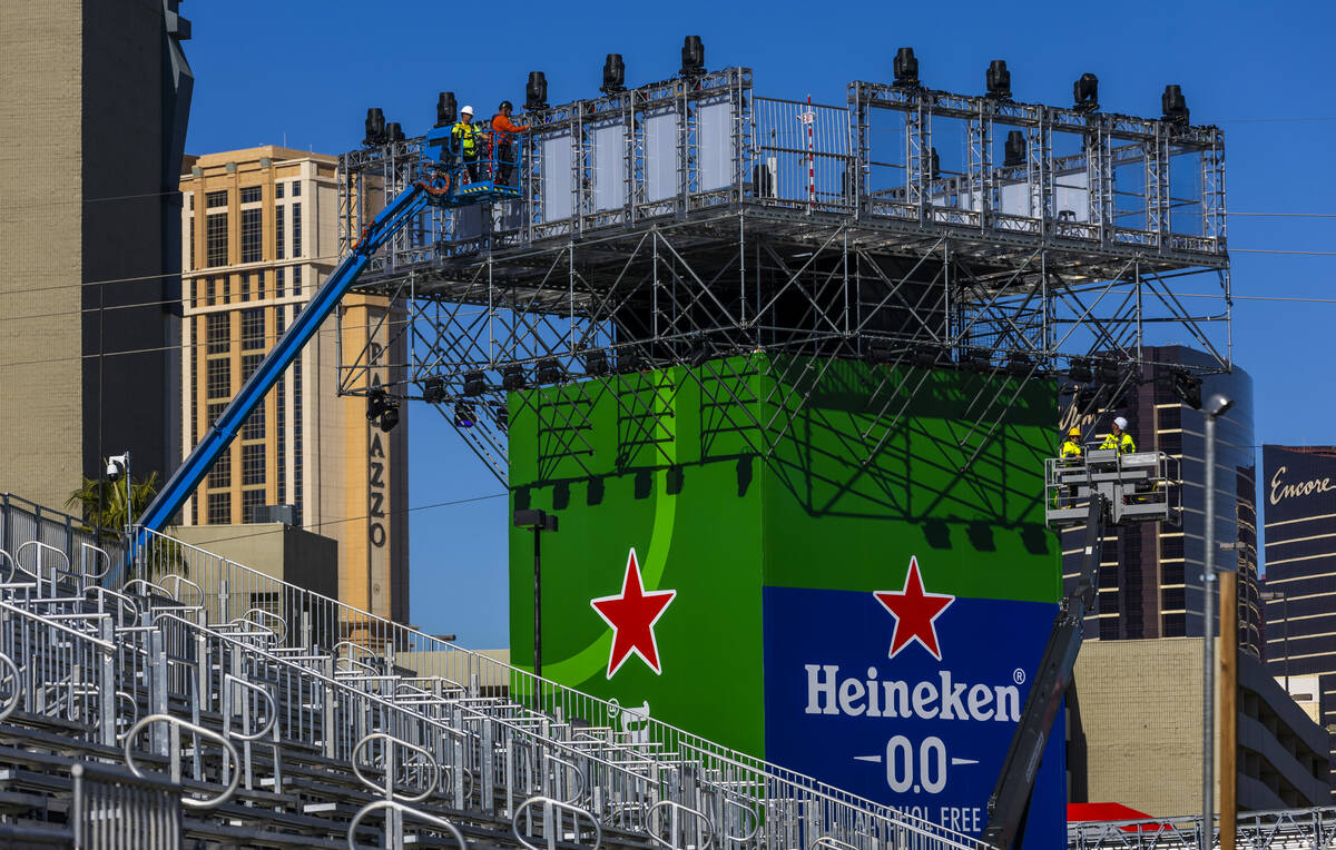 Workers complete a tower along Koval Lane as F1 infrastructure construction continues along the ...