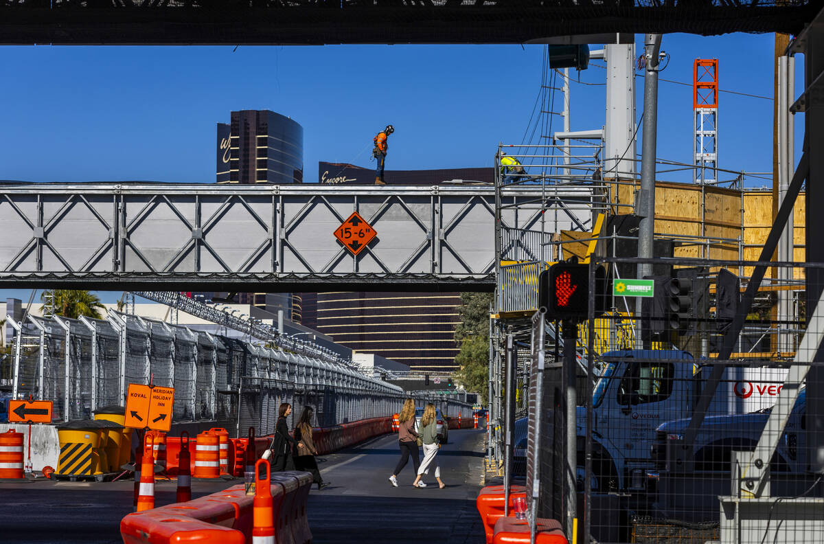 Pedestrians and traffic navigate barricades and other race barriers along Koval Lane at the Fla ...