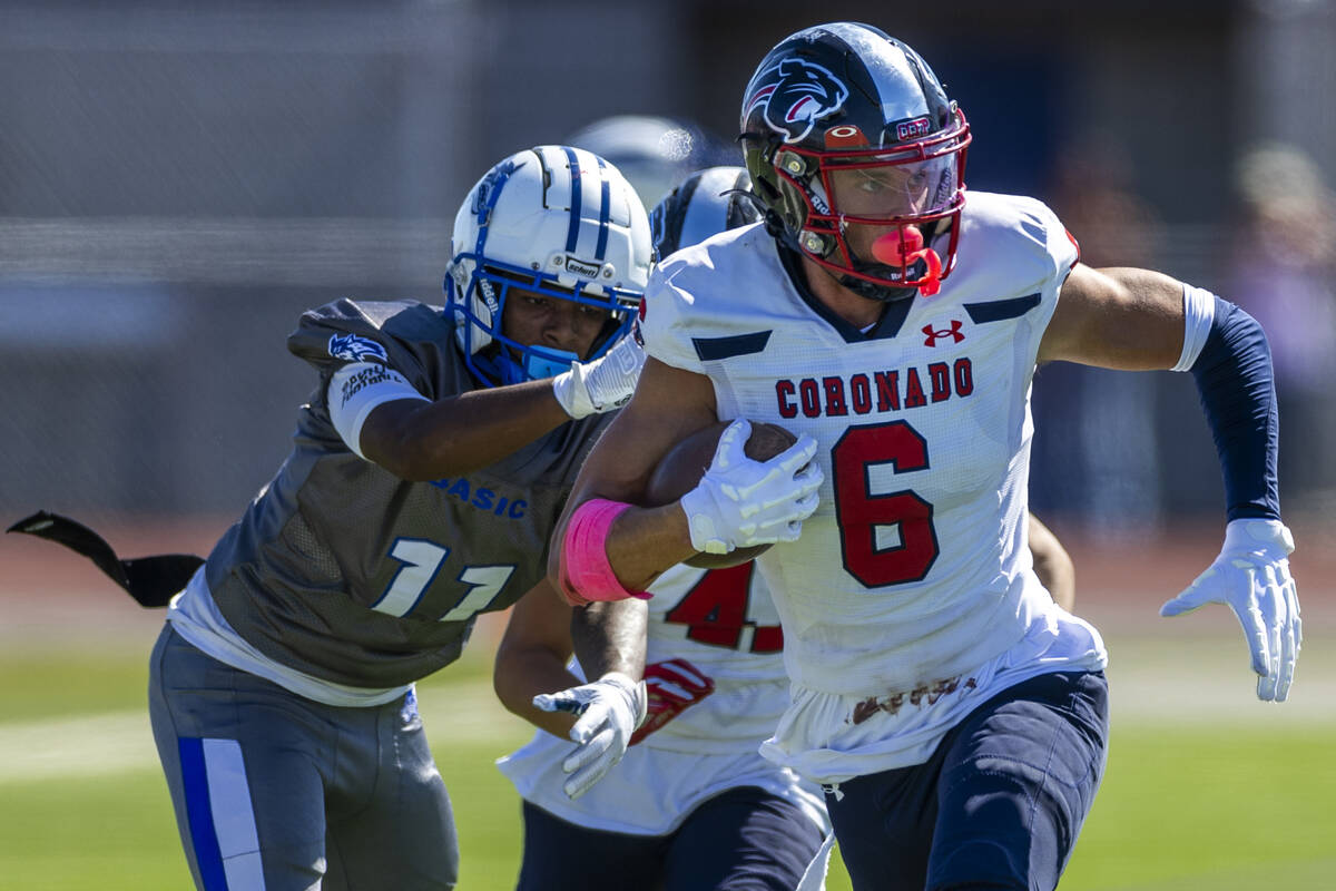 Coronado defensive back JJ Buchanan (6) brushes off a tackle attempt after an interception by B ...