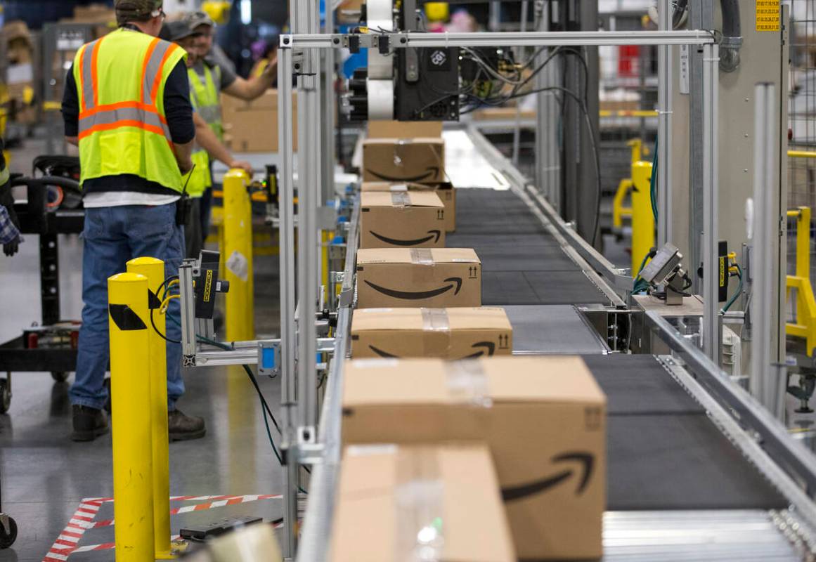 Boxes move down a conveyor belt during a tour of Amazon's North Las Vegas fulfillment center. A ...