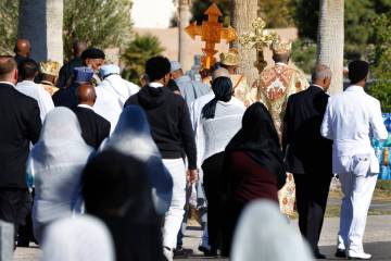 Mourners and Orthodox Church priests arrive for a burial service at Palm Eastern Mortuary and C ...