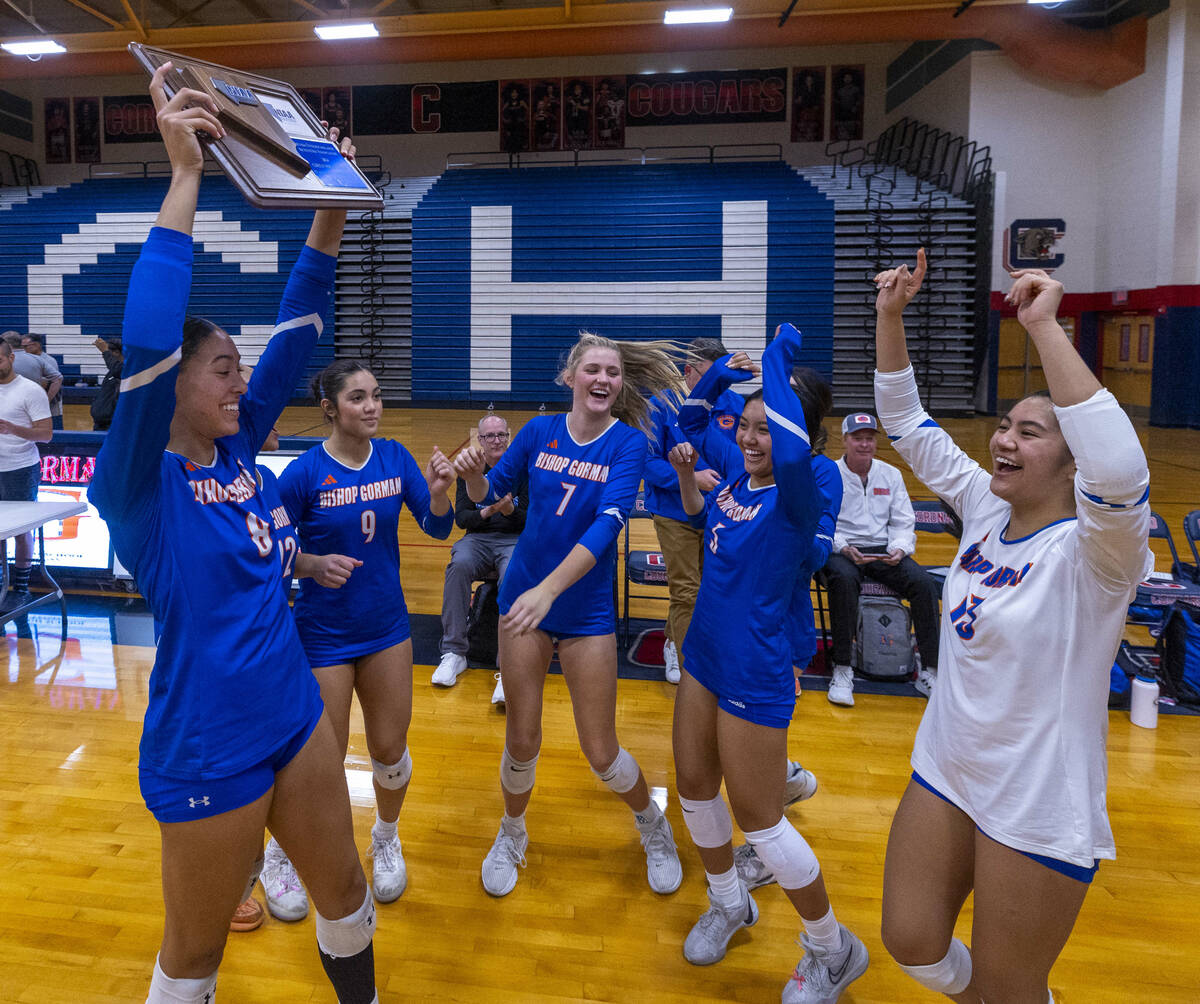 Bishop Gorman players celebrate their trophy with a win against Coronado in their Class 5A girl ...