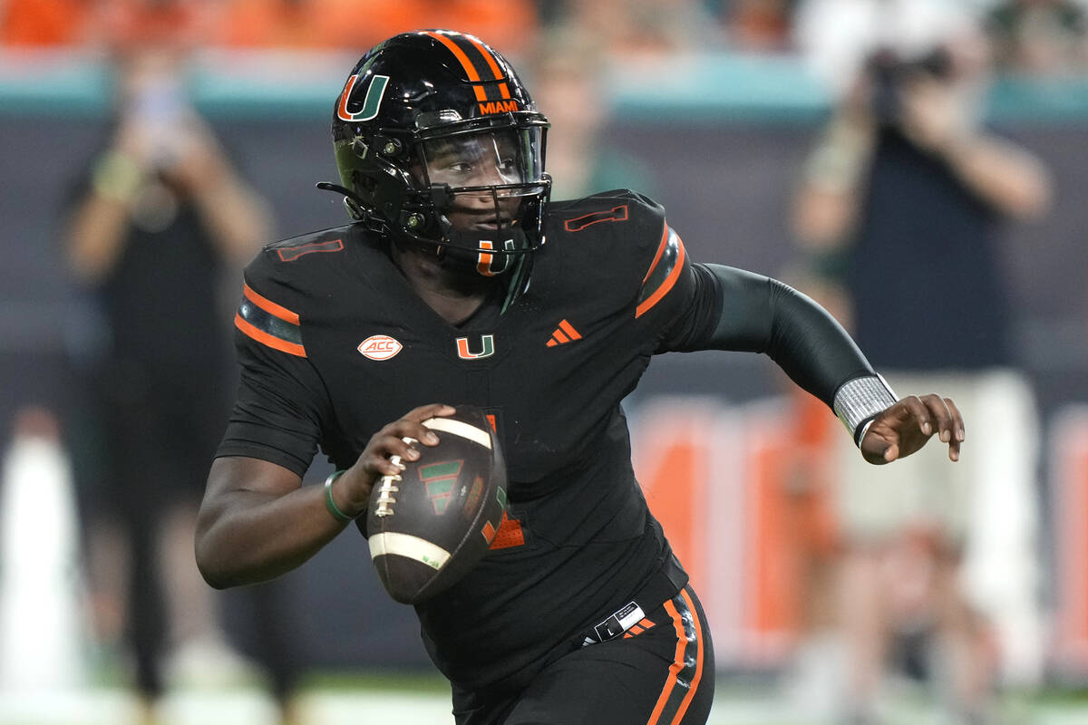 Miami quarterback Cam Ward looks to pass during the first half of an NCAA college football game ...