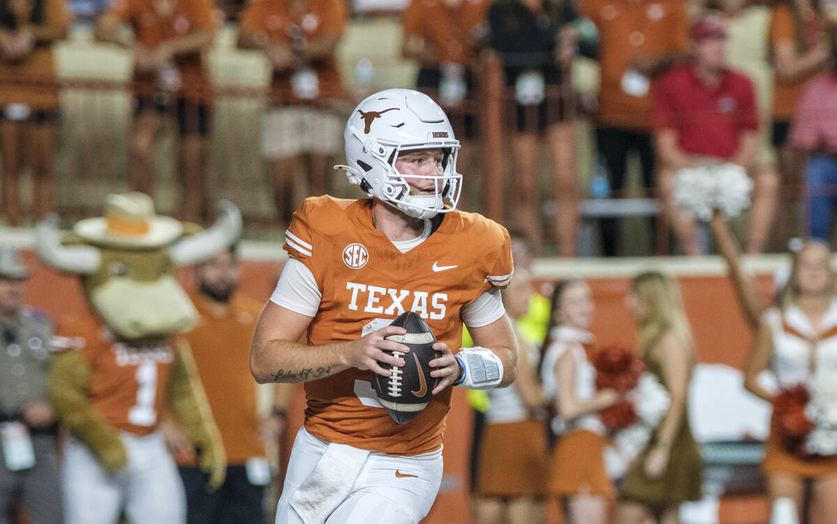 Texas quarterback Quinn Ewers (3) looks down field against Georgia during the second half of an ...