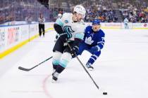 Toronto Maple Leafs' Bobby McMann (74) trails behind Seattle Kraken's Chandler Stephenson (9) a ...