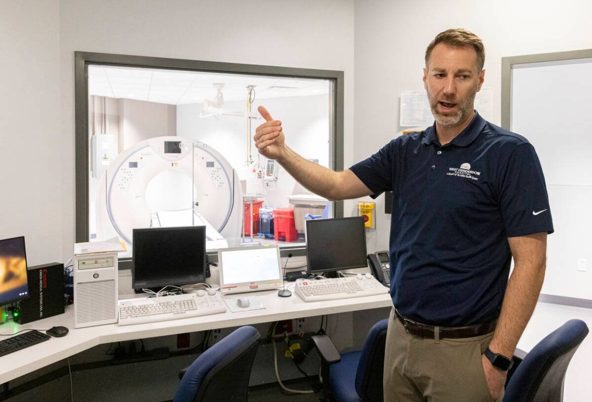 Chris Loftus, CEO of West Henderson Hospital, leads a tour of the CT scan control room at the n ...